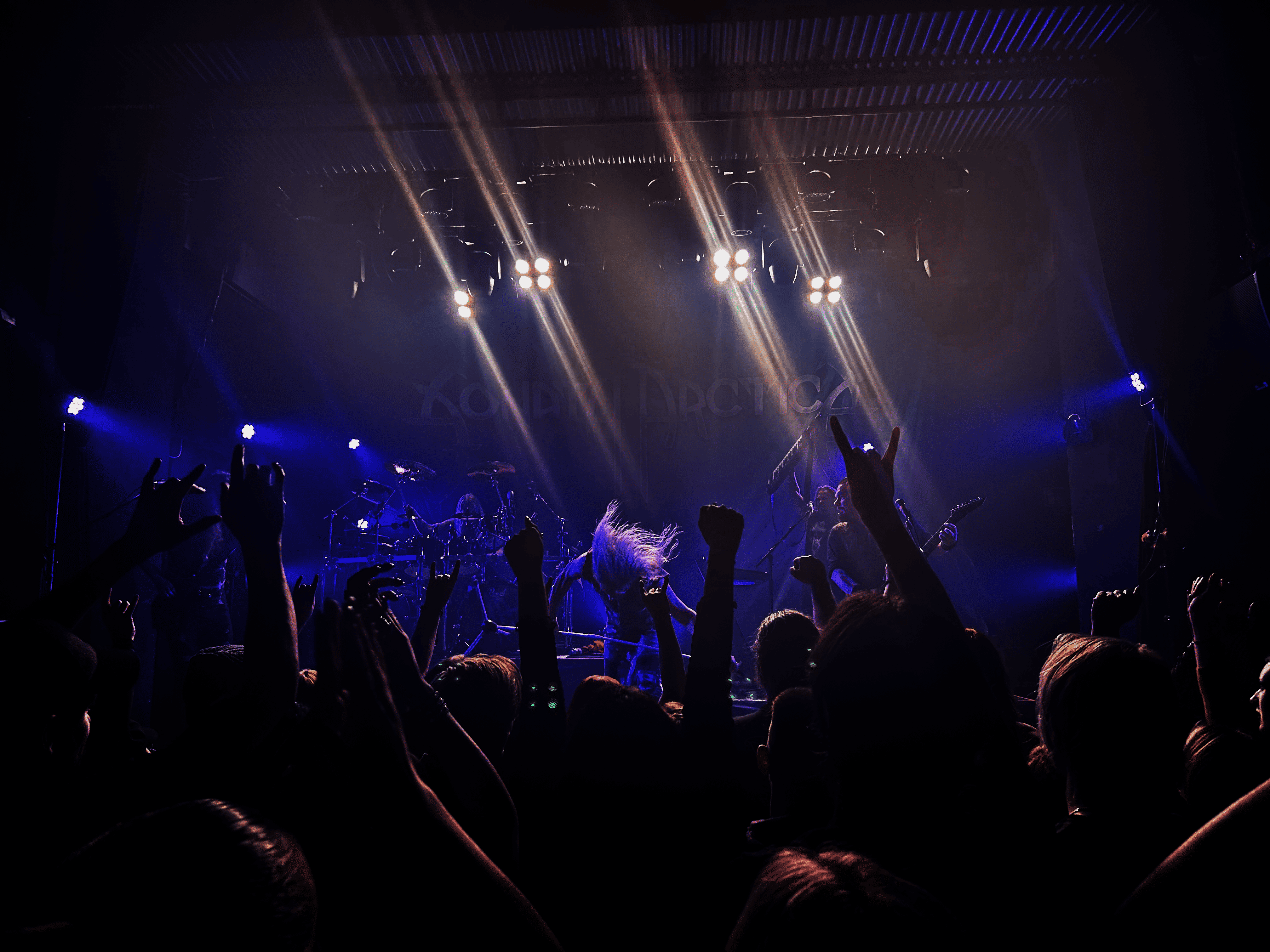 La imagen captura la esencia vibrante de un concierto de metal en vivo...